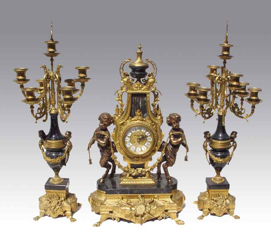 Appraisal: IMPERIAL FIGURAL CLOCK GARNITURE SET Figural pan children cast metal