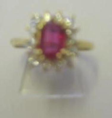 Appraisal: A RUBY AND DIAMOND CLUSTER RING the emerald cut ruby