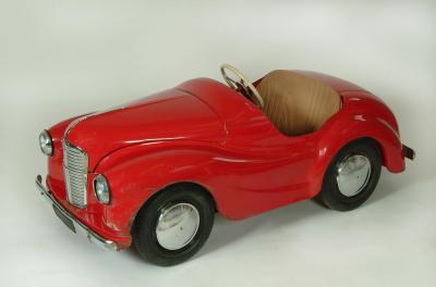 Appraisal: A Triang J Austin pedal car in red tin plate