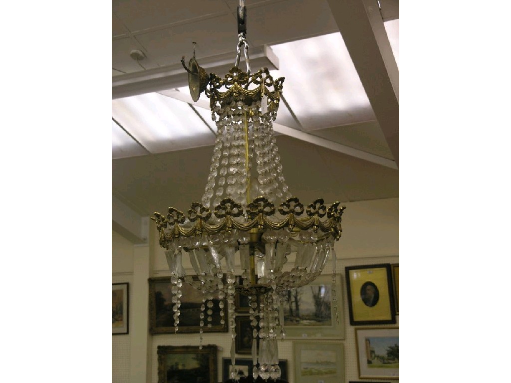 Appraisal: A large brass electric chandelier circular shape with numerous strands