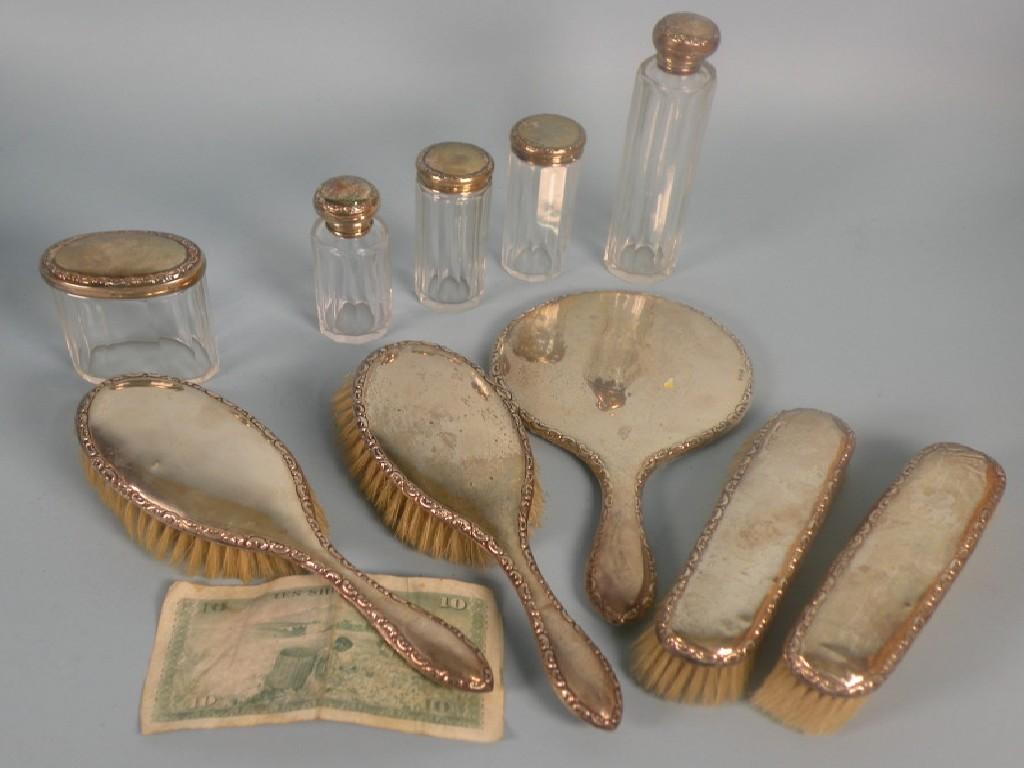 Appraisal: A silver mounted part dressing table set comprising five glass