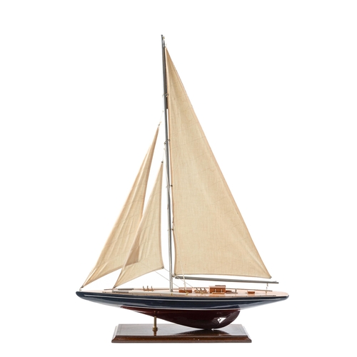 Appraisal: A painted wood model yacht with cotton sails and rigging