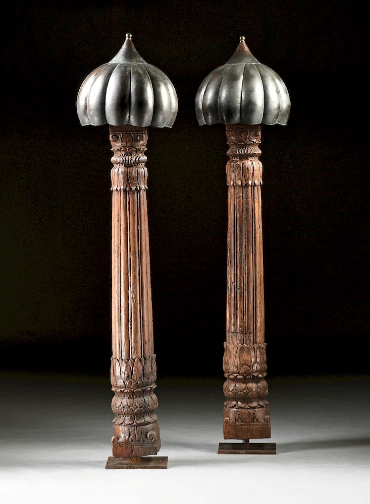 Appraisal: A PAIR OF INDO ISLAMIC CARVED WOOD COLUMNAR FLOOR LAMPS