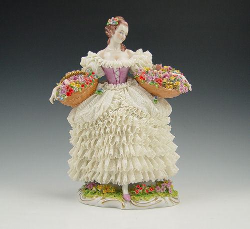 Appraisal: SITZENDORF LARGE LACY FIGURE Woman with baskets overflowing with flowers