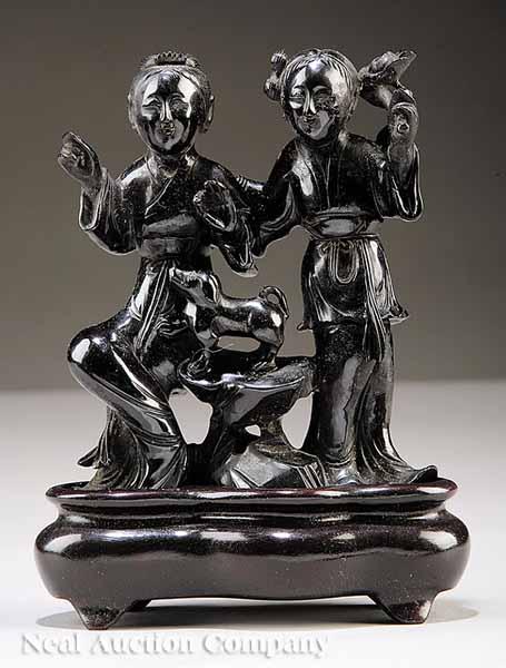 Appraisal: A Chinese Carved Amber Figural Group of Two Children and