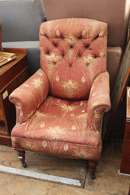 Appraisal: A VICTORIAN ARMCHAIR with button upholstered back and turned front