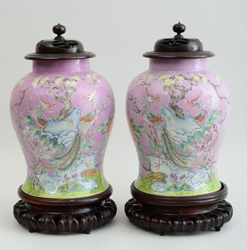 Appraisal: PAIR OF INCISED PINK-GROUND FAMILLE ROSE PORCELAIN JARS WITH HARDWOOD