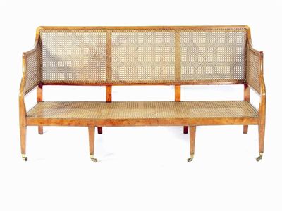 Appraisal: A th century satinwood and cane three seater settee with