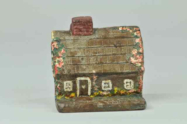 Appraisal: 'HARLOW HOUSE'' DOORSTOP BOOK EXAMPLE cast iron depicts Historical brown