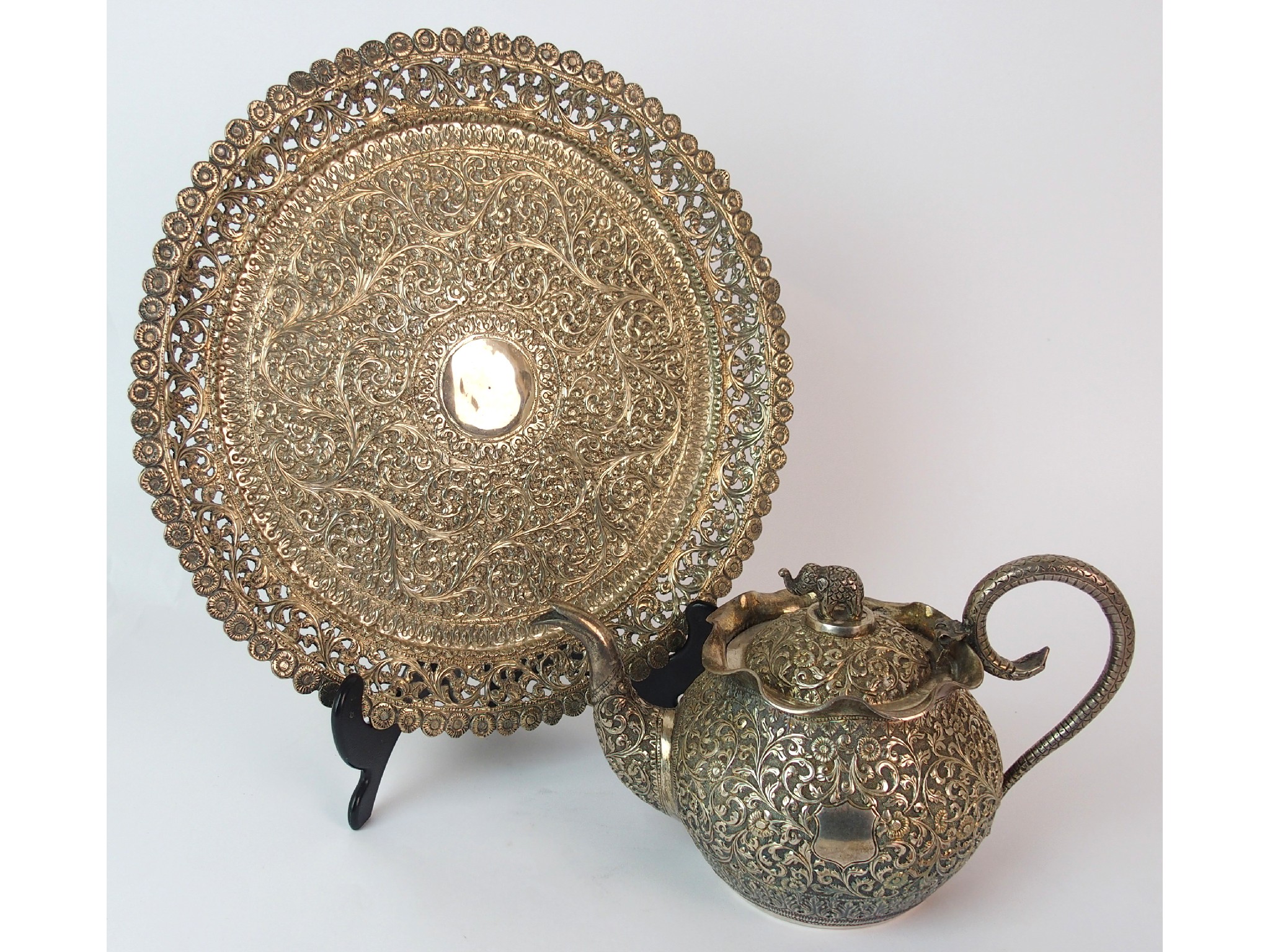 Appraisal: An Indian silver teapot and coverchased allover with foliage divided