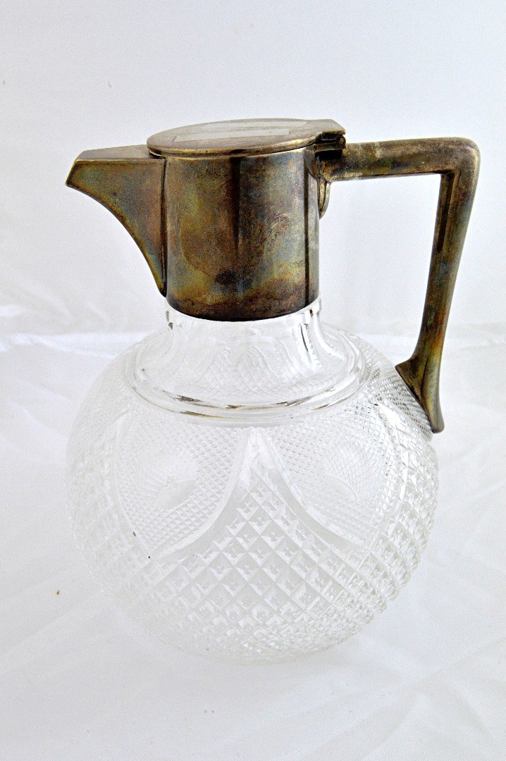 Appraisal: A silver mounted faceted glass claret jug the body of