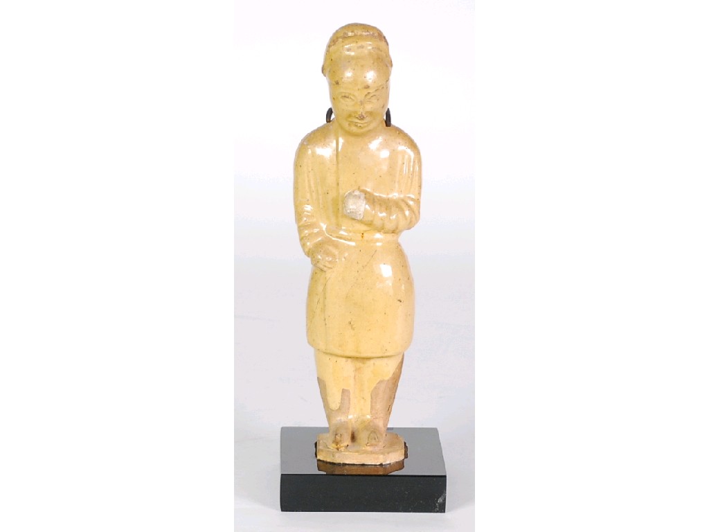 Appraisal: A CHINESE TANG DYNASTY YELLOW GLAZED POTTERY FIGURE OF A