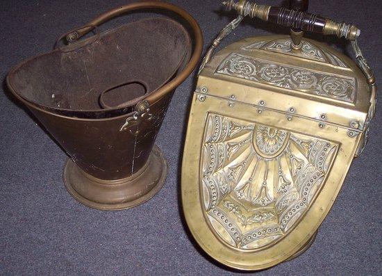 Appraisal: An embossed brass coal scuttle with hinged cover and shovel