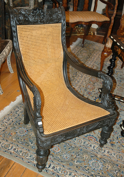 Appraisal: A GOOD ANGLO INDIAN EBONY ARMCHAIR The crest rail with