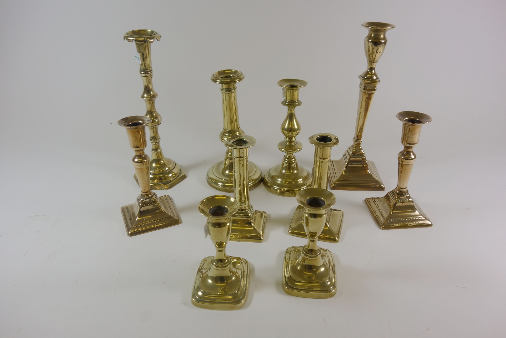 Appraisal: A pair of George III bell metal candlesticks with bead