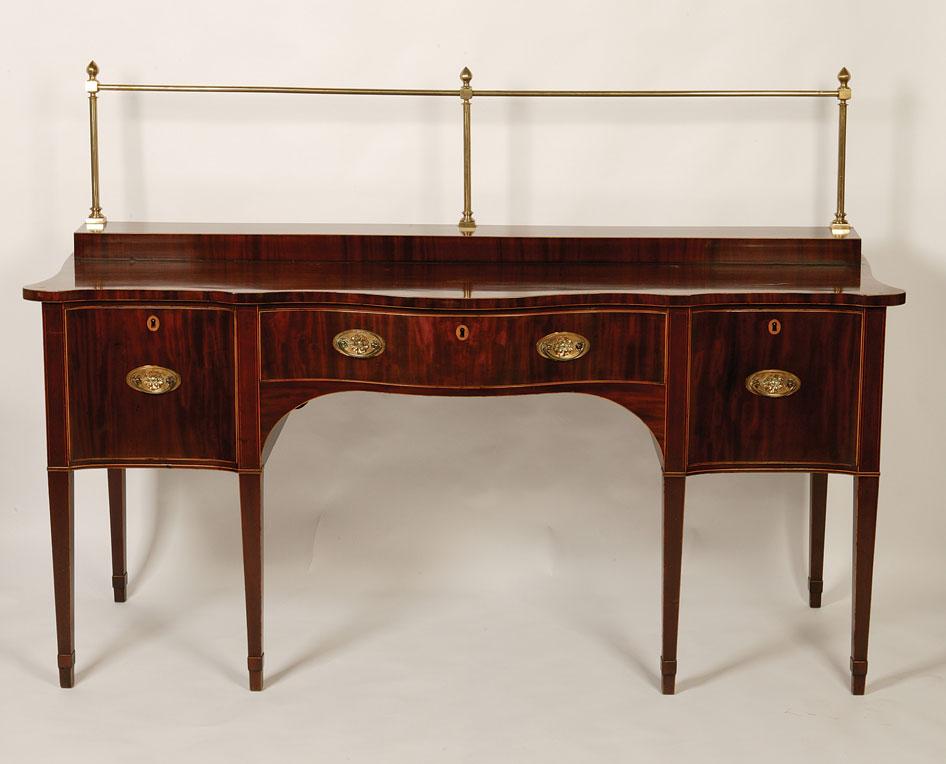 Appraisal: A GEORGE III MAHOGANY SERPENTINE SIDEBOARD the shaped top with