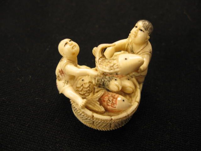 Appraisal: Carved Ivory Netsuke man son with large tub of fish