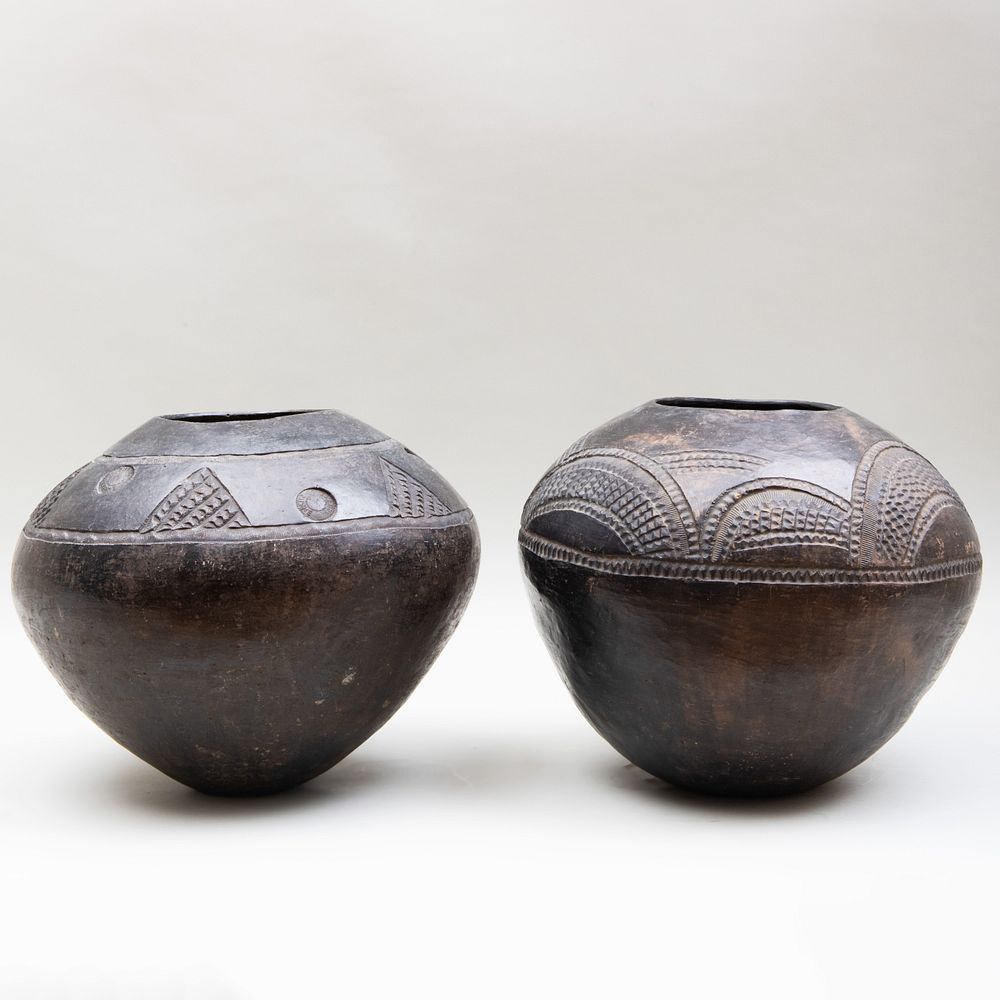 Appraisal: Two Burnished and Carved Black Pottery Vases Possibly African Both