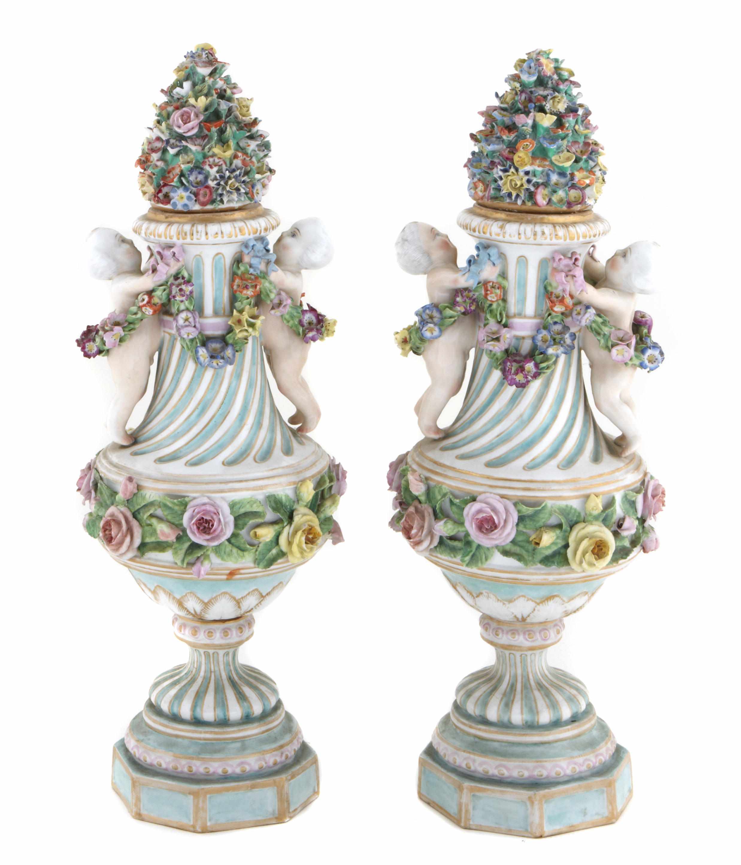 Appraisal: A pair of German porcelain floral encrusted figural covered urns