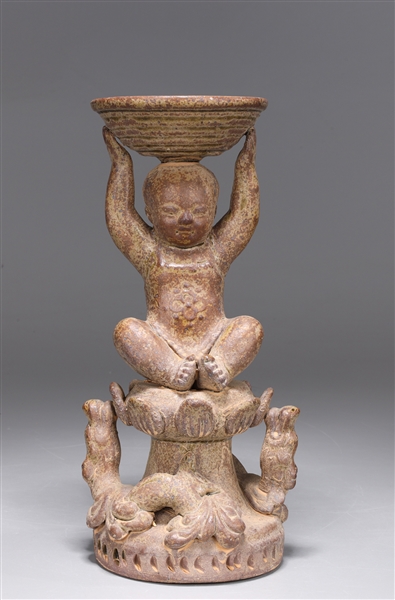 Appraisal: Unique Chinese molded and parcel-glazed pottery figural candlestick of baby