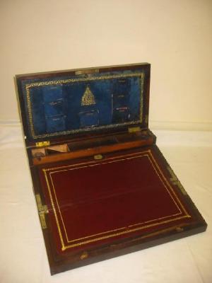 Appraisal: A ROSEWOOD AND BRASS BOUND WRITING SLOPE with campaign handles