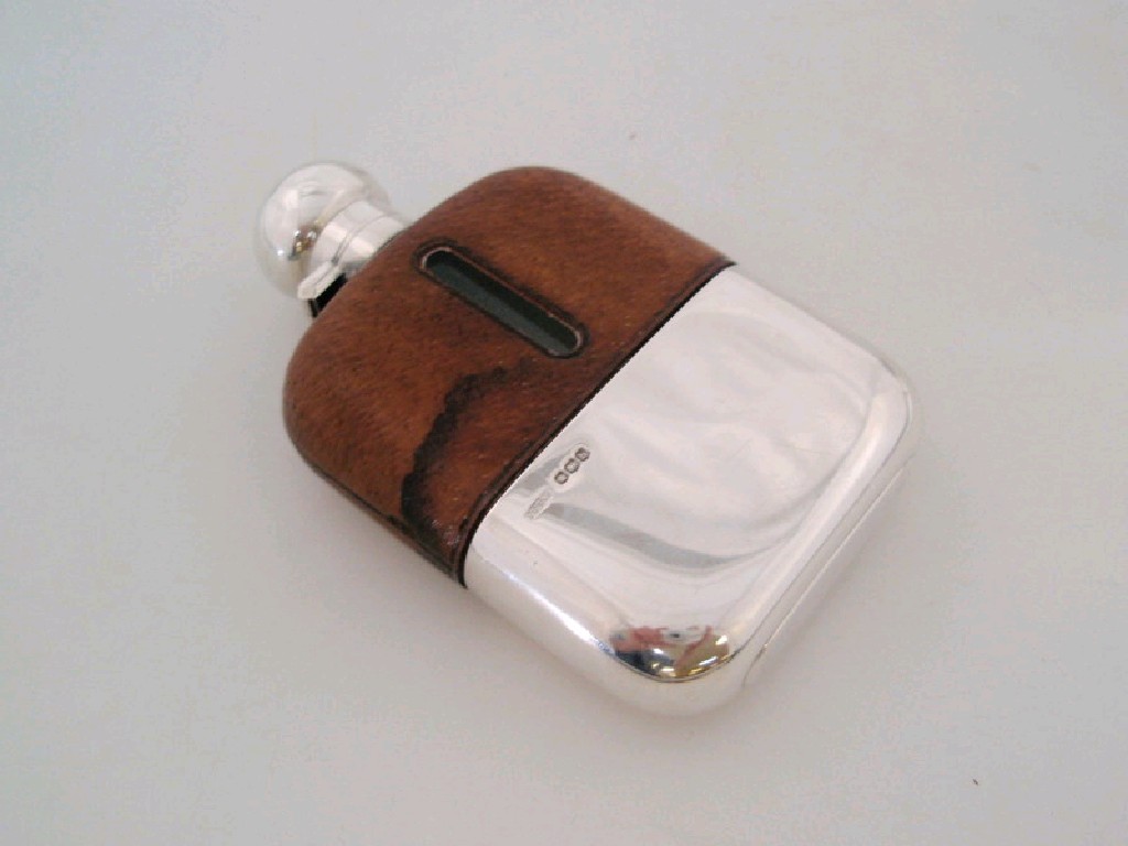 Appraisal: A silver hip flask with leather cover Sheffield assay