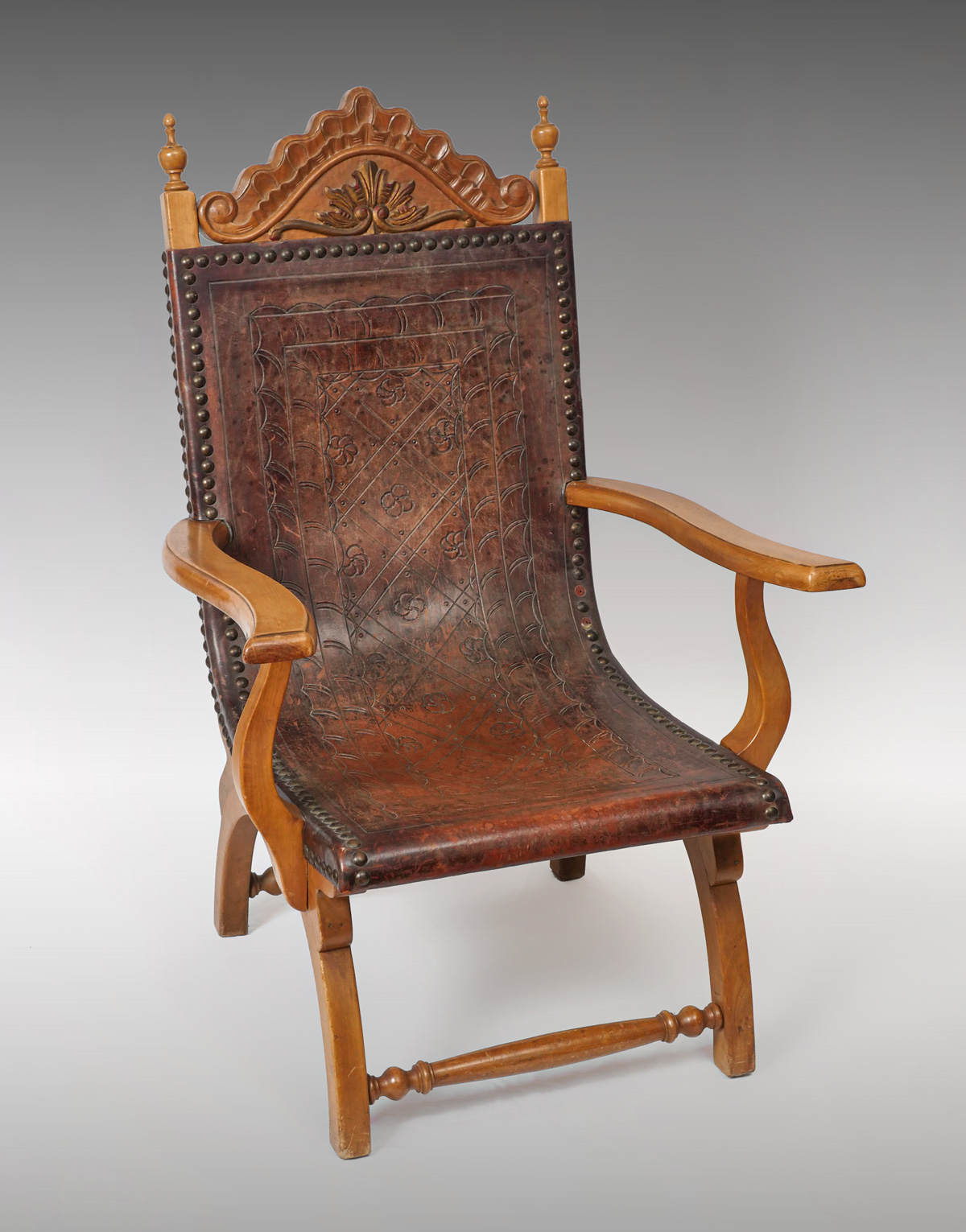 Appraisal: SPANISH EMBOSSED LEATHER CHAIR Spanish leather armchair having a tooled