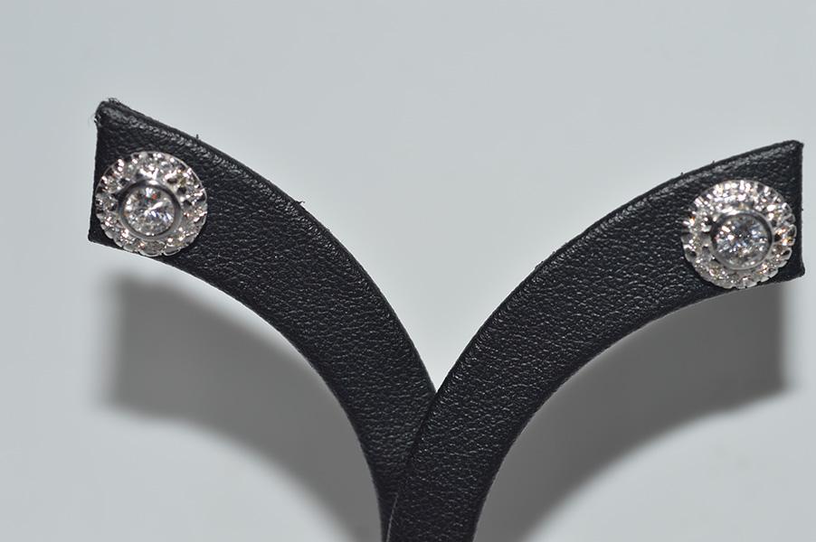 Appraisal: A PAIR OF DIAMOND CLUSTER EARRINGS IN CT WHITE GOLD