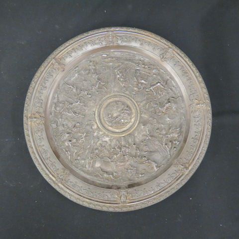 Appraisal: th Century Iron Charger elaborate festive scenes bronzed finish diameter