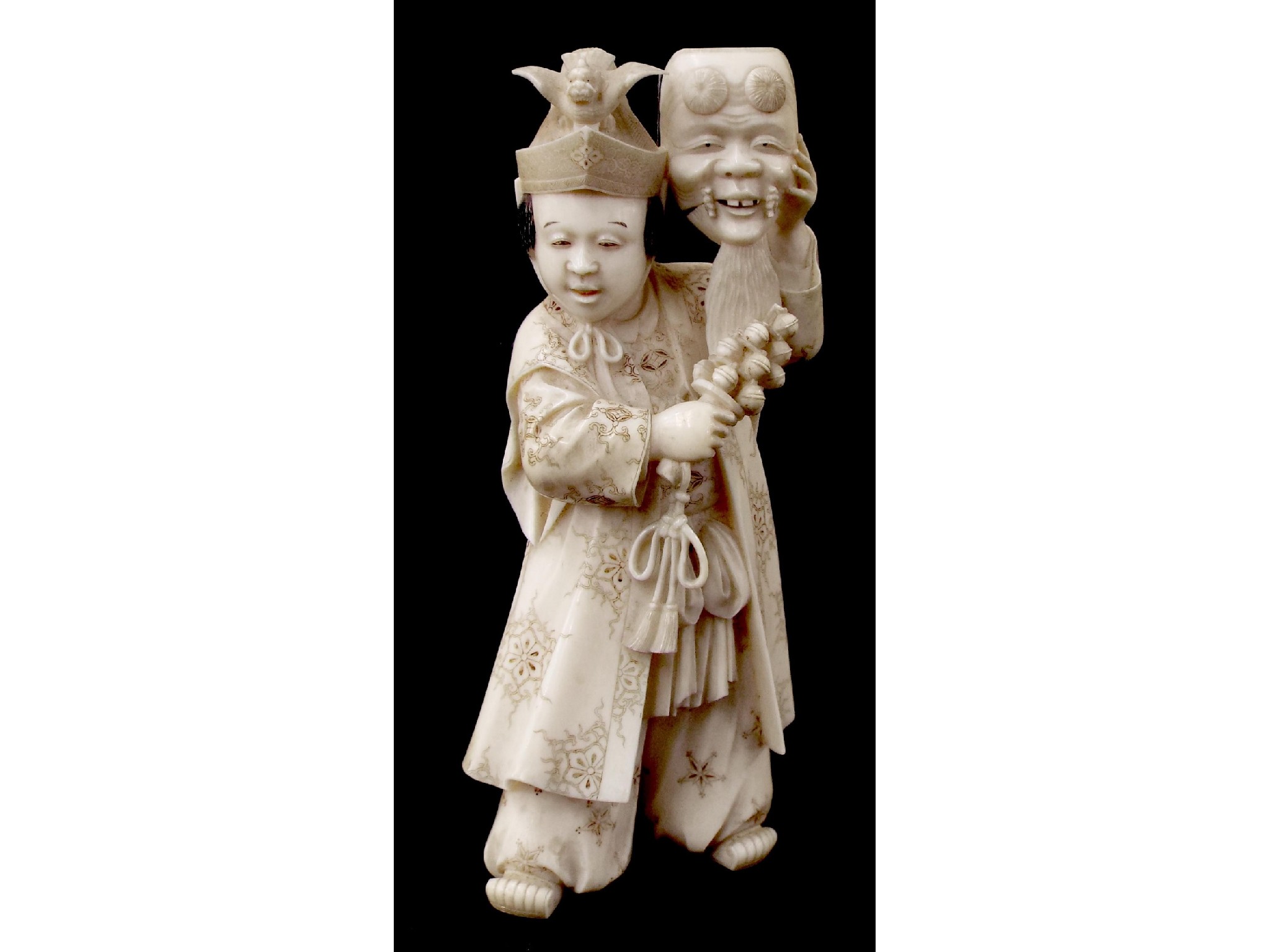 Appraisal: Japanese ivory okimono finely modelled as a theatrical performer holding