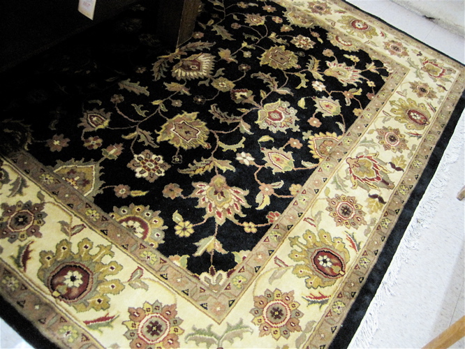 Appraisal: HAND KNOTTED ORIENTAL CARPET Indo-Persian the rectangular black field decorated