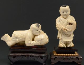 Appraisal: TWO CARVED IVORY FIGURES OF BOYS Chinese One holding a