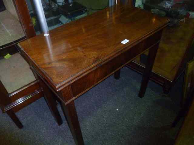 Appraisal: A GEORGIAN MAHOGANY FOLDOVER TOP TEA TABLE on square cut