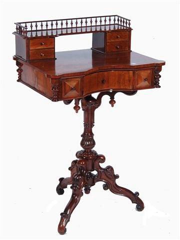 Appraisal: A VICTORIAN ROSEWOOD LADIES WRITING DESK with fret gallery fitted