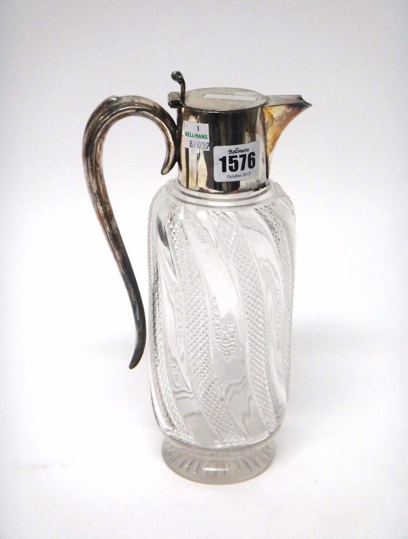 Appraisal: A silver plated metal mounted faceted glass claret jug decorated