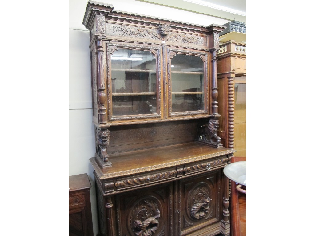 Appraisal: Victorian carved oak bookcase on cupboard base