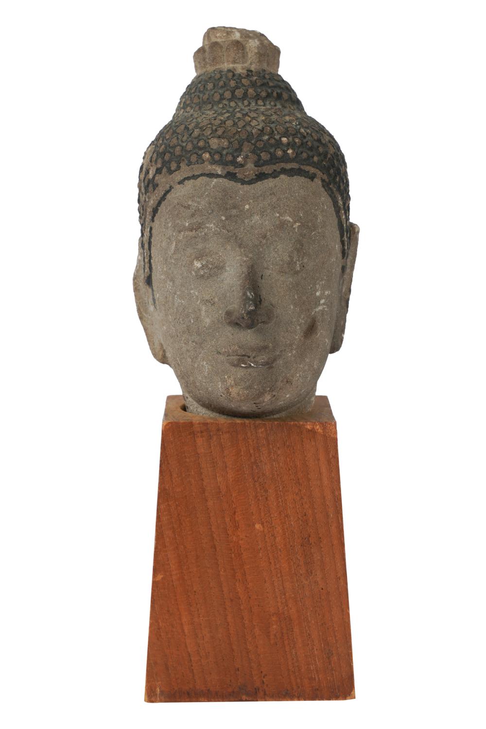 Appraisal: SOUTHEAST ASIAN CARVED STONE BUDDHA HEADwith a later wood pedestal