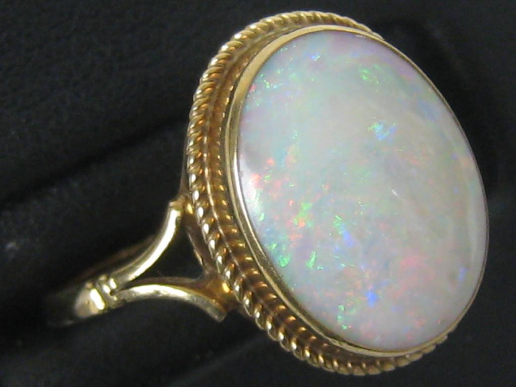 Appraisal: An Opal Dress Ring the oval cabochon in rub-over setting