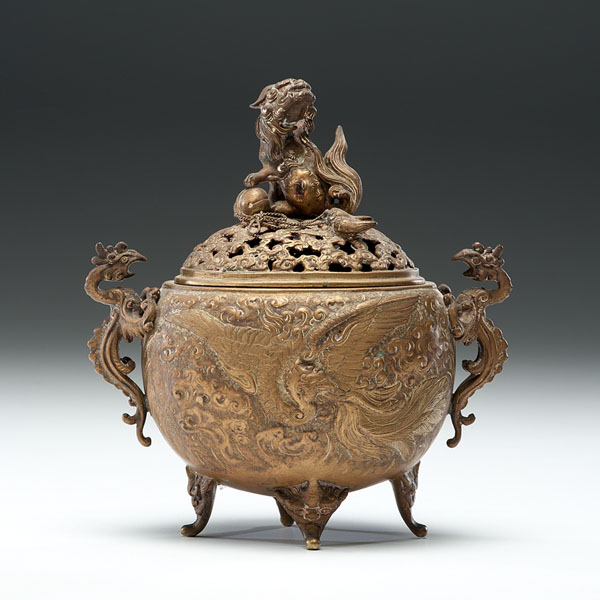 Appraisal: Chinese A four-footed cast bronze censor having a pierced lid