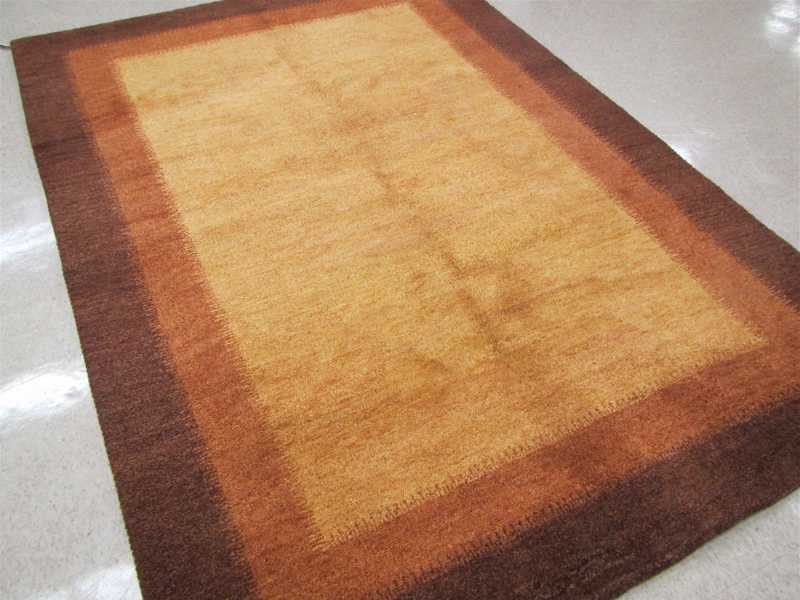 Appraisal: A CONTEMPORARY HAND KNOTTED CARPET Indo-Gabbeh plain golden brown field