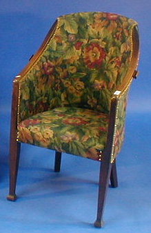 Appraisal: An Arts Crafts oak tub chair with floral upholstery