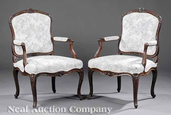 Appraisal: A Pair of Louis XV Carved Walnut Fauteuils mid- th