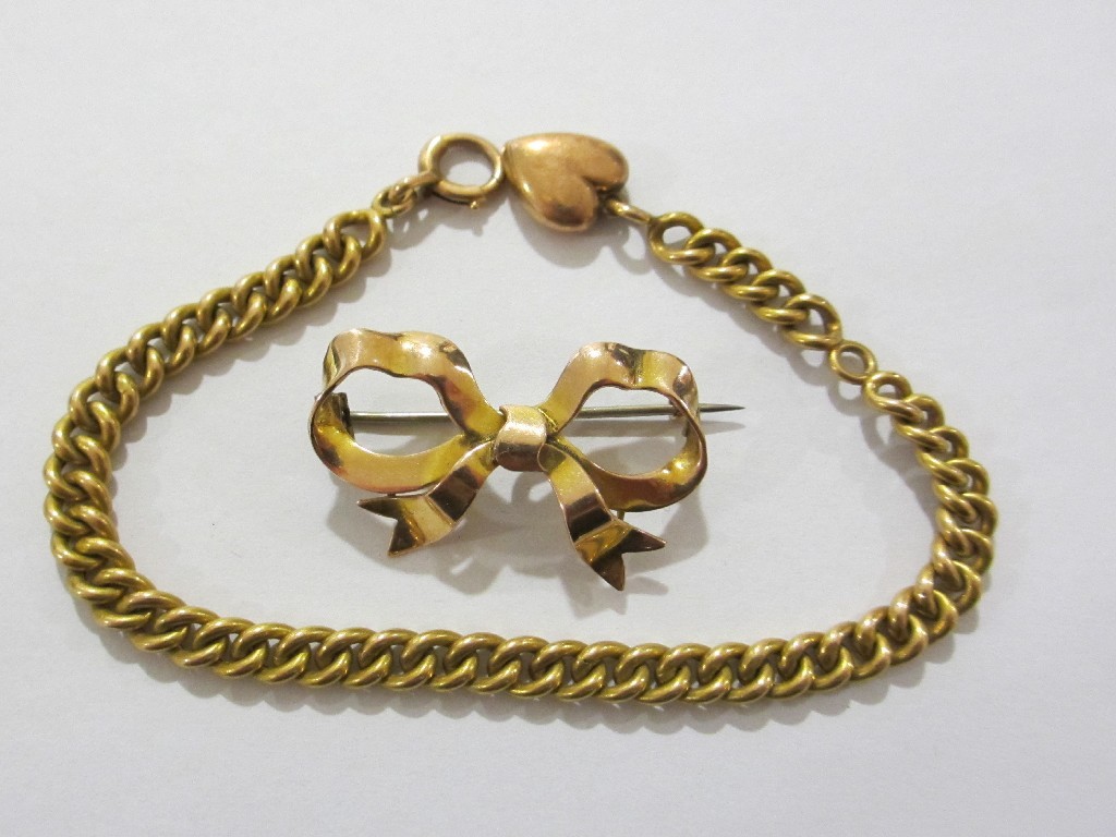 Appraisal: Lot comprising a ct gold bow brooch and a yellow