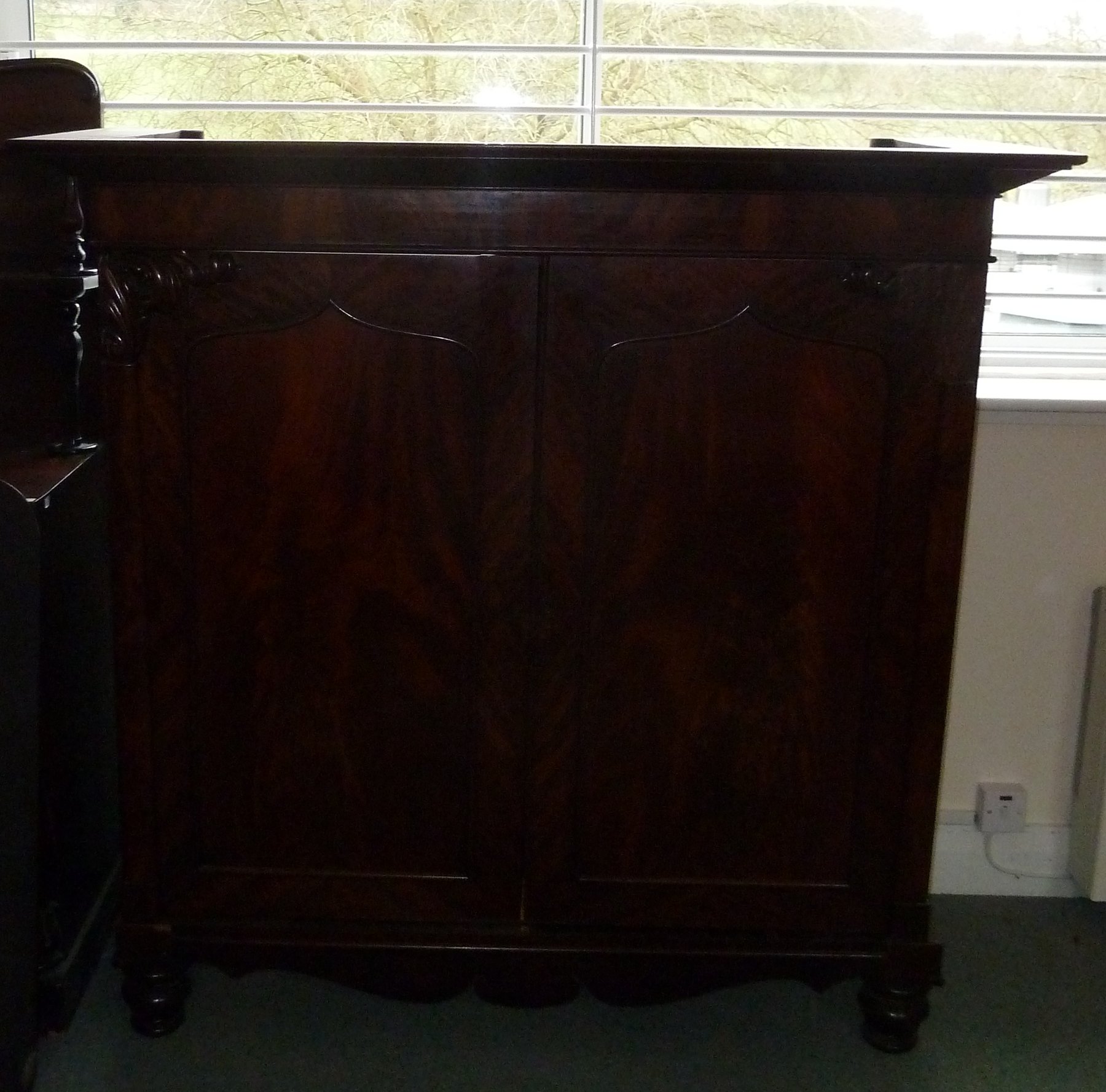 Appraisal: A Regency mahogany press cupboard with moulded cornice enclosed by