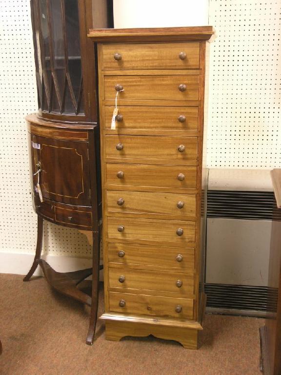 Appraisal: A reproduction mahogany Wellington chest ten drawers each with turned