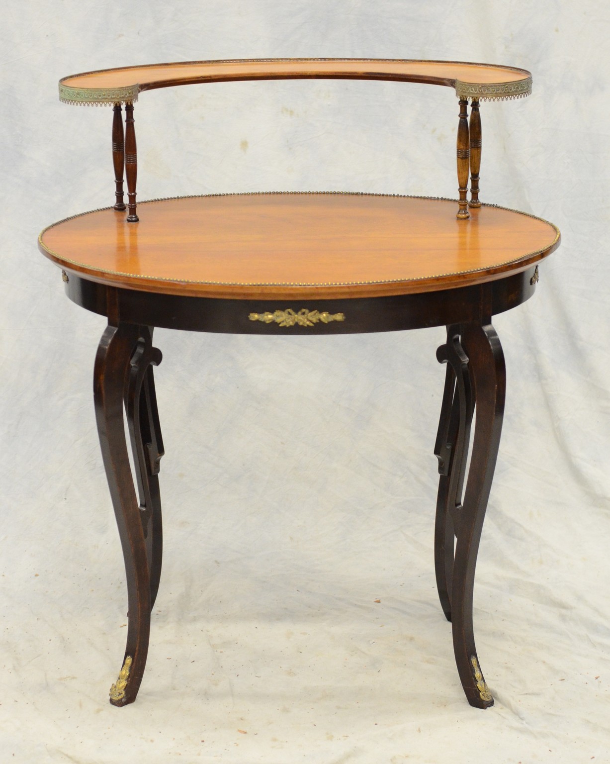 Appraisal: Oval two- tier French style side table with brass mounts