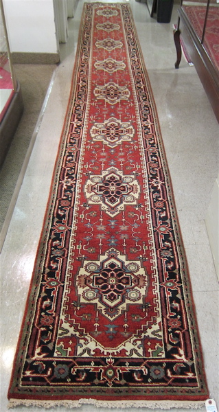 Appraisal: HAND KNOTTED ORIENTAL LONG RUG Persian Serapi design of repeating