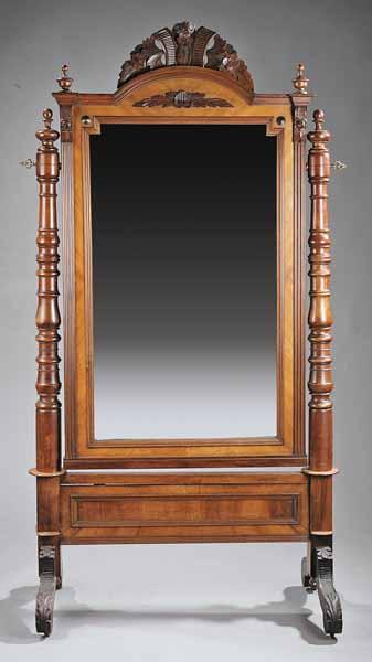 Appraisal: A Victorian Walnut Cheval Mirror the carved crest over an