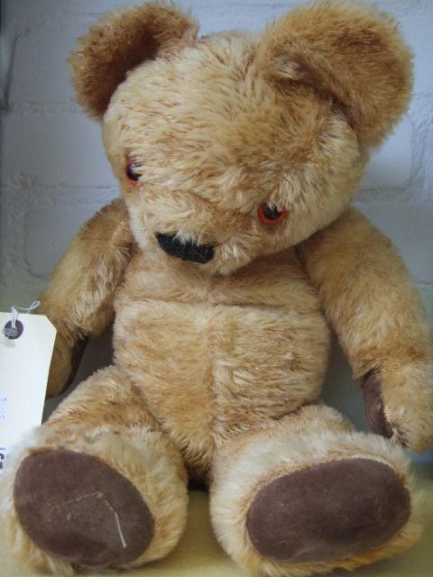 Appraisal: A golden haired teddy bear mid th century with jointed