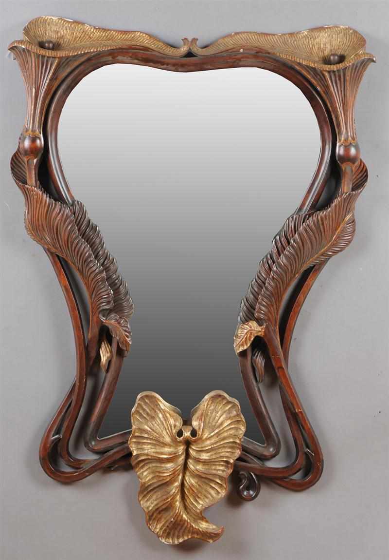 Appraisal: PAIR OF ART NOUVEAU STYLE CARVED WALNUT AND PARCEL-GILT MIRRORS